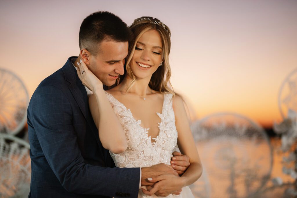 bride and groom against the backdrop of a yellow sunset