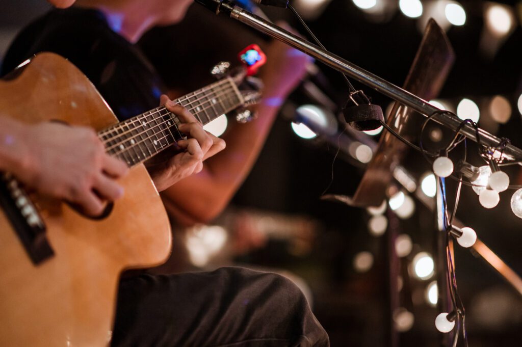 The musician plays and the lead singer sings on stage at the music festival at night.
Concert,mini concert and music festivals.